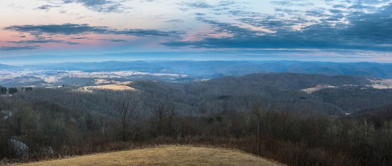 Wide angle of landscape against cloudy sky