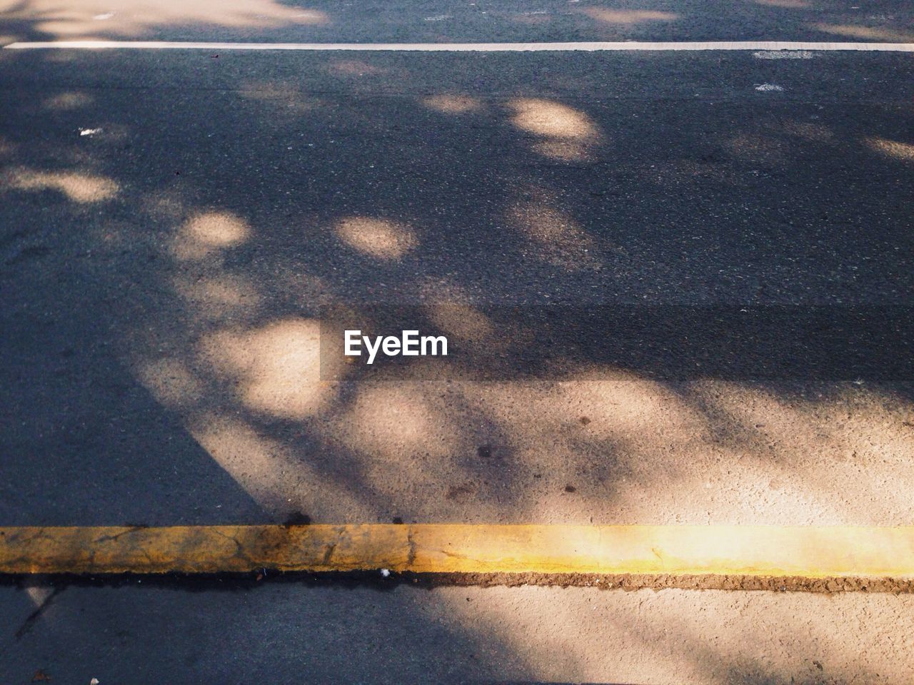 Close-up of yellow line on road