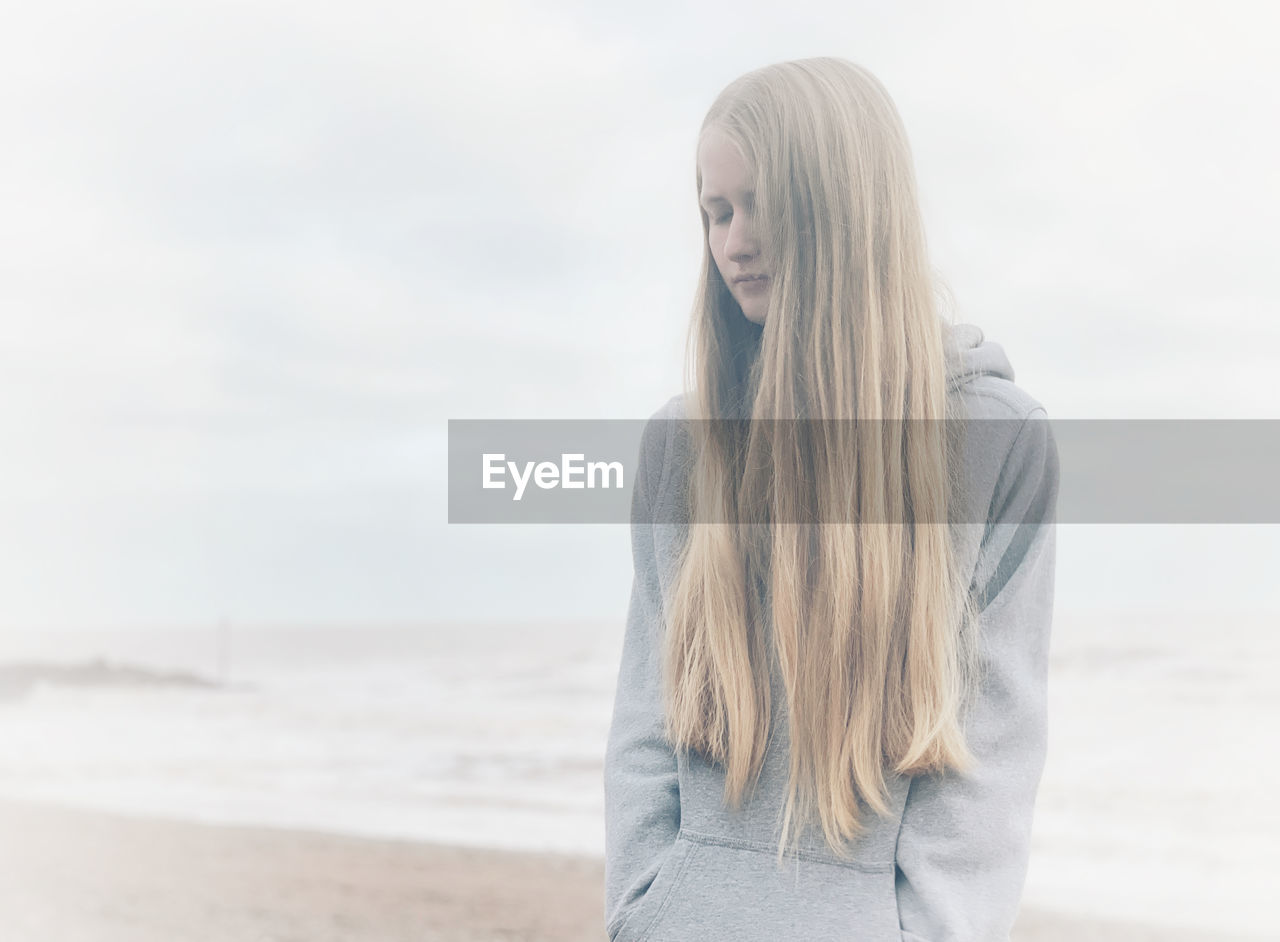 Teenager girl standing on beach