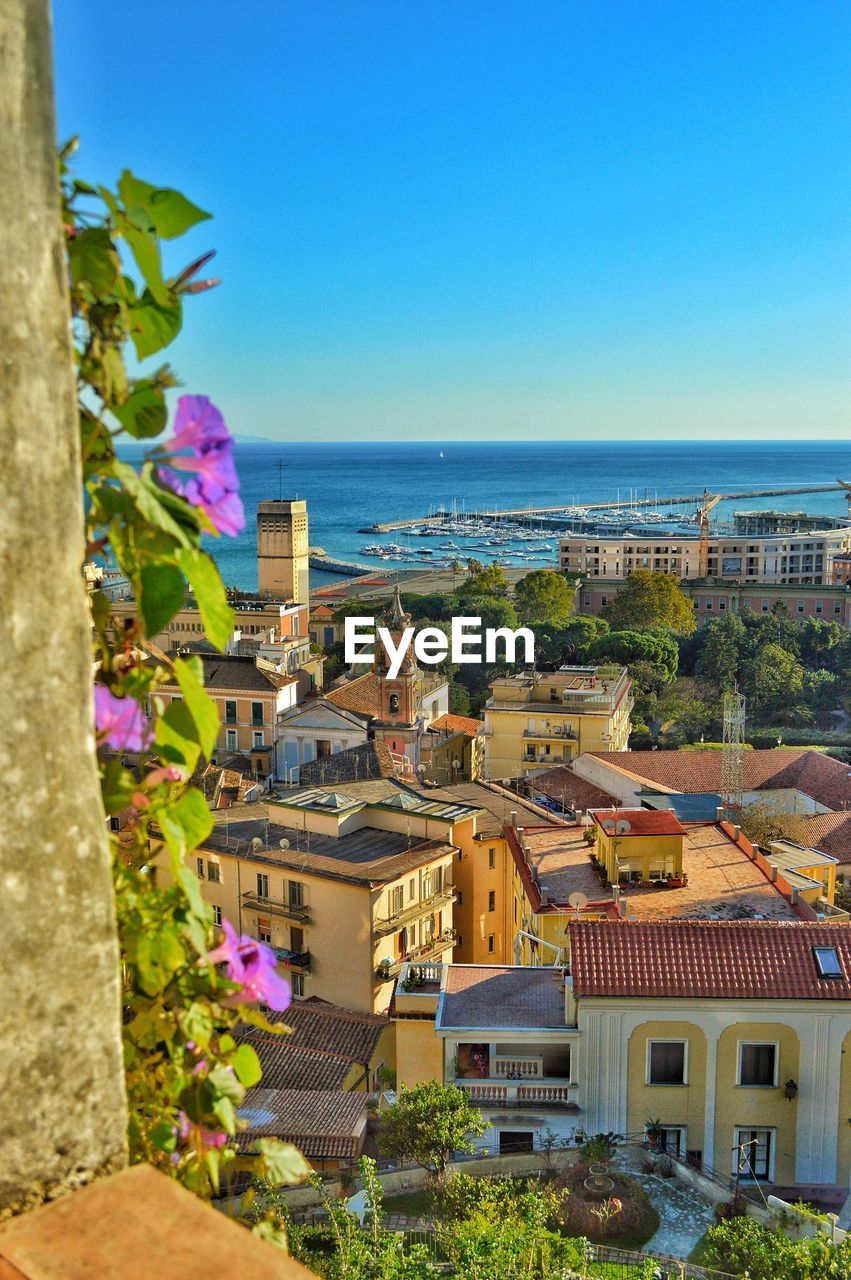 BUILDINGS IN SEA AGAINST CLEAR BLUE SKY