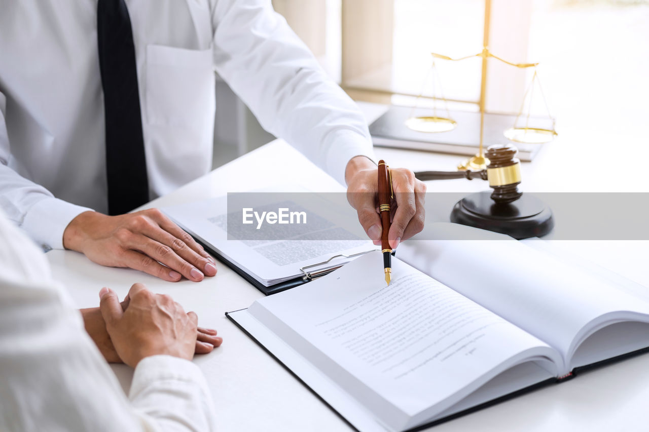 High angle view of judge with client at desk in office