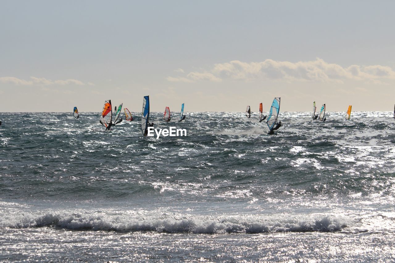 VIEW OF PEOPLE ON SEA AGAINST SKY