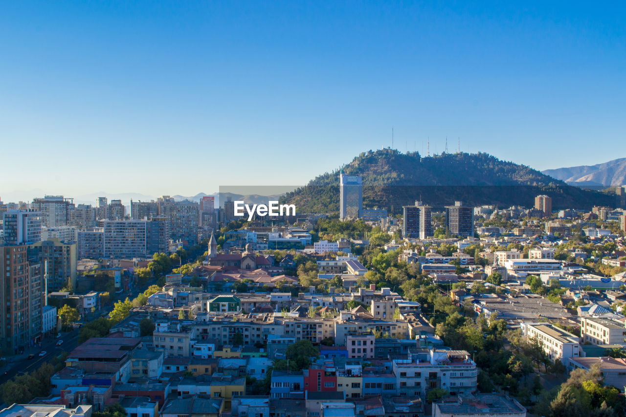 Cityscape against clear blue sky