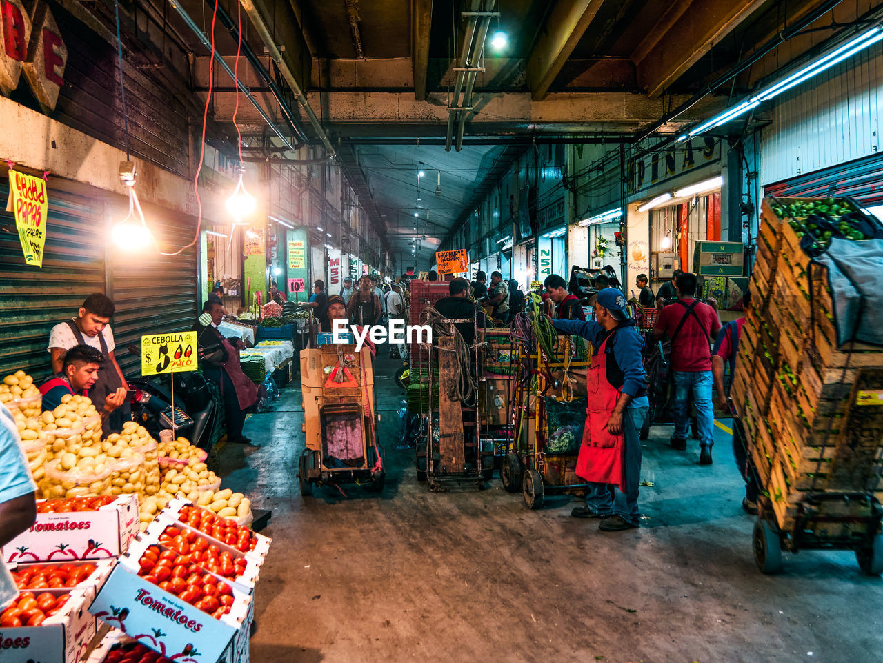 GROUP OF PEOPLE IN MARKET STALL