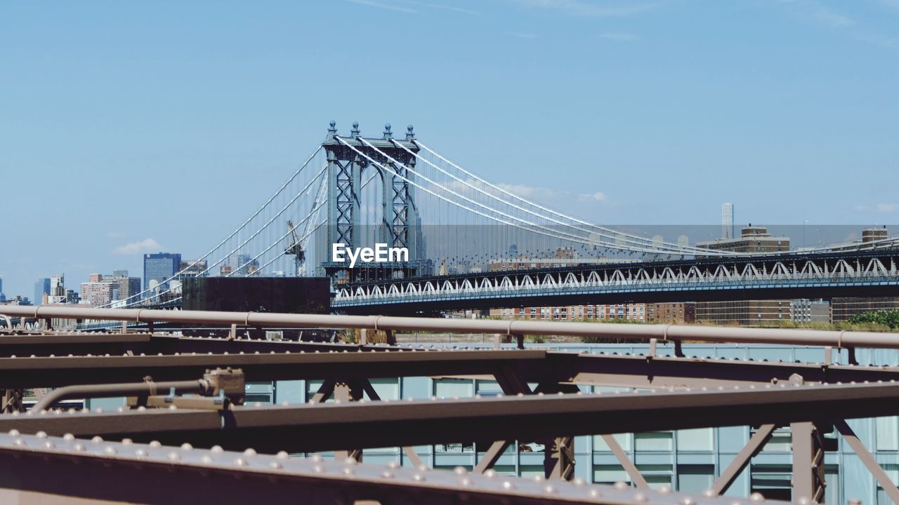 Low angle view of suspension bridge against sky