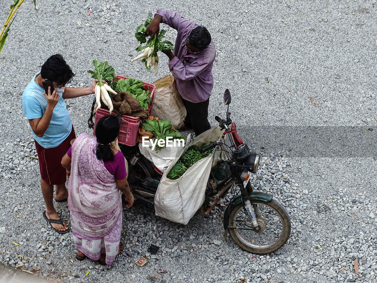 HIGH ANGLE VIEW OF WOMAN WITH UMBRELLA ON STREET