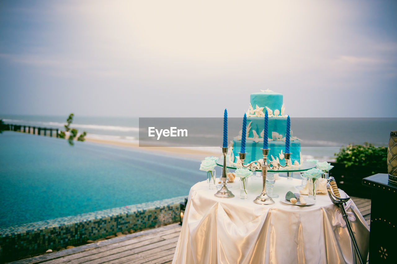 Blue wedding cake on wedding ceremony at seaside