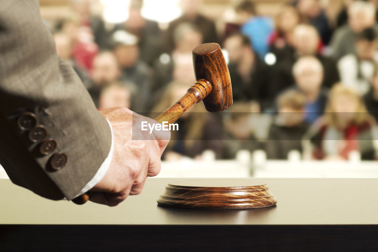 Close-up of judge hammering on gavel in court