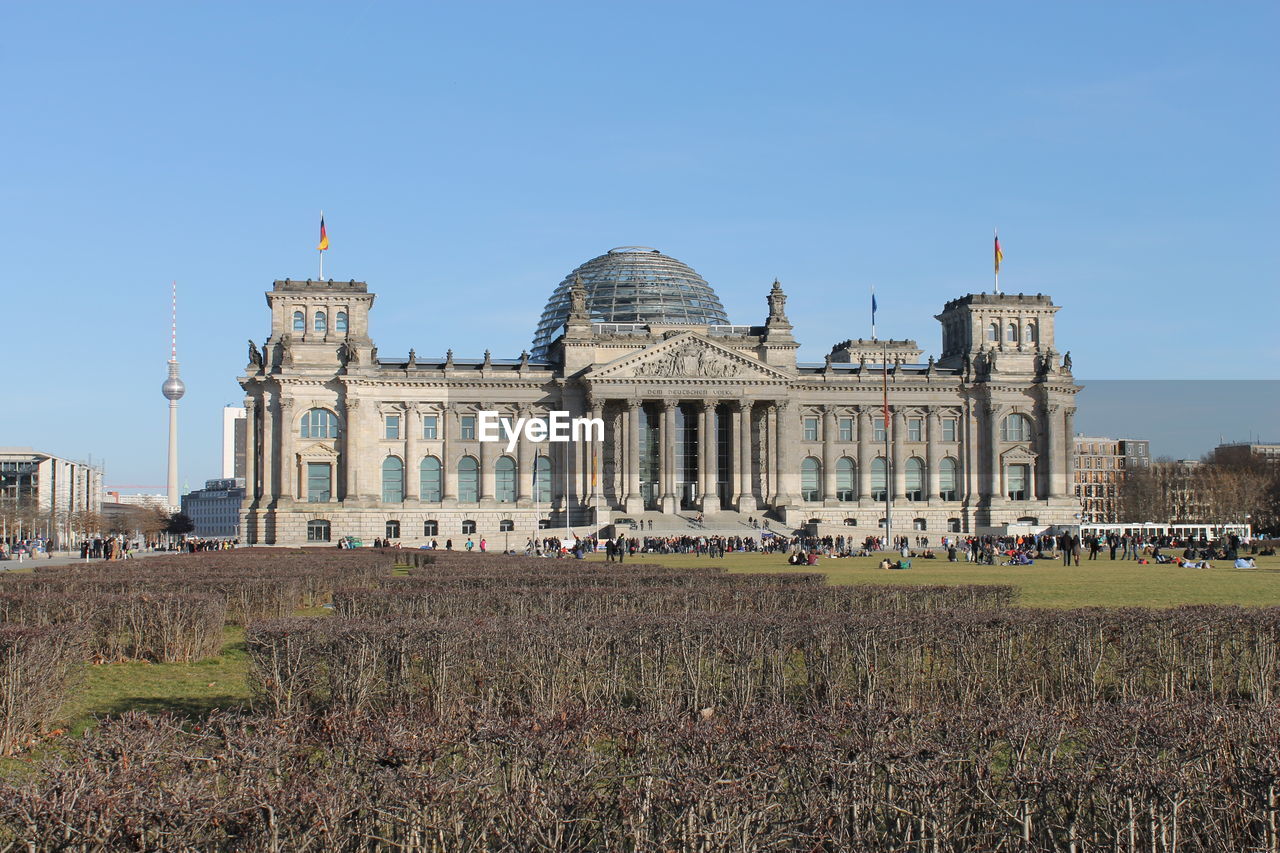 Facade of lawn against clear blue sky