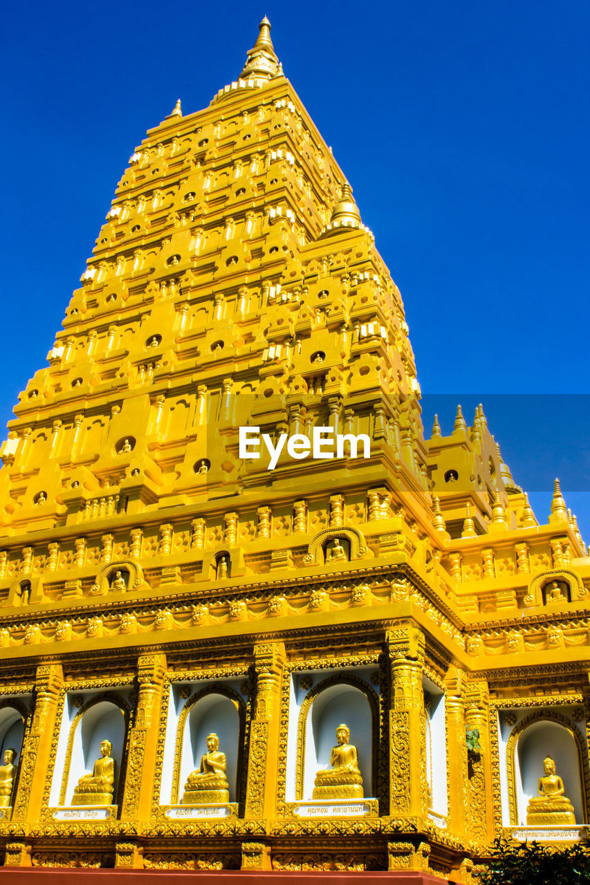 Low angle view of temple building against clear blue sky