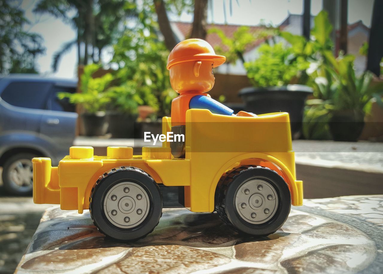 Close-up of toy truck figurine on marble