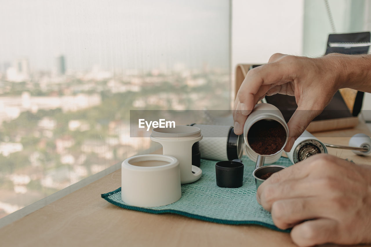 cropped image of hand holding coffee cup