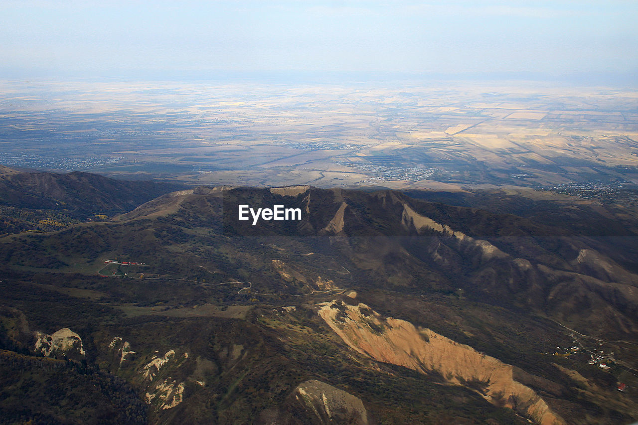 A view over the mountain valley and fields in the distance in autumn, sunlight, aerial photography