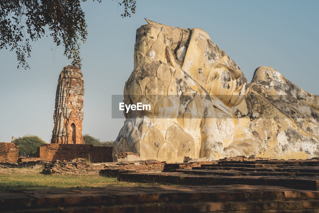 rock, ancient history, travel destinations, nature, sky, landmark, architecture, history, travel, landscape, no people, the past, ancient, ruins, temple, environment, rock formation, arch, plant, land, clear sky, monument, outdoors, scenics - nature, tree, tourism, beauty in nature, built structure, old ruin, day, formation, mountain, tranquility, religion, temple - building, sunny