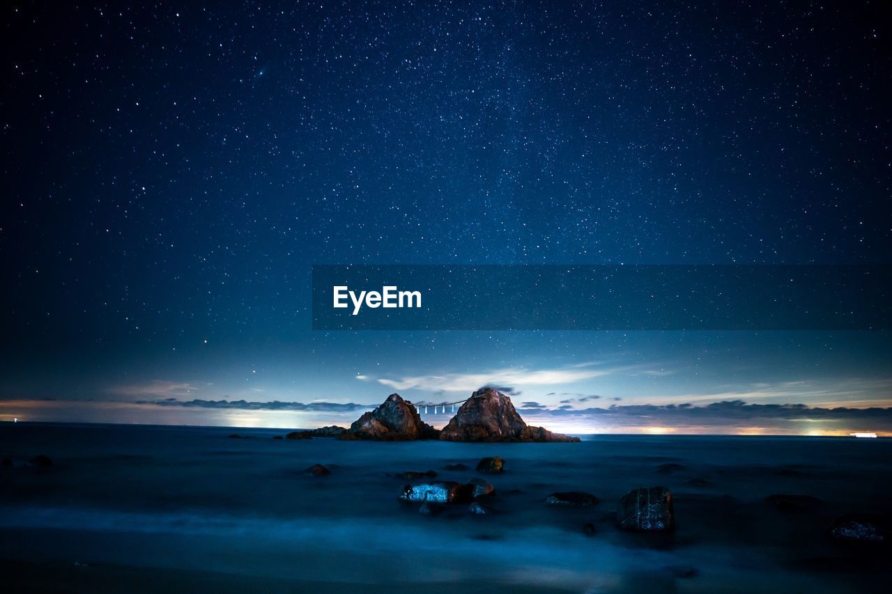 Scenic view of sea against sky at night