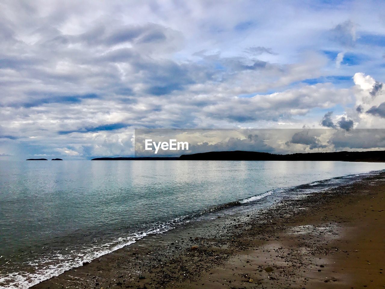 VIEW OF SEA AGAINST CLOUDY SKY