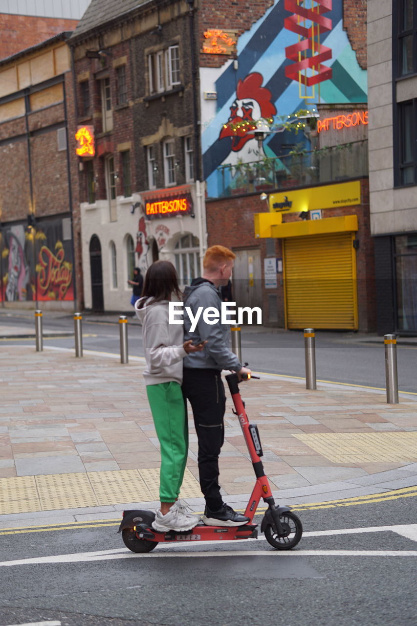 FULL LENGTH REAR VIEW OF PEOPLE WALKING ON STREET