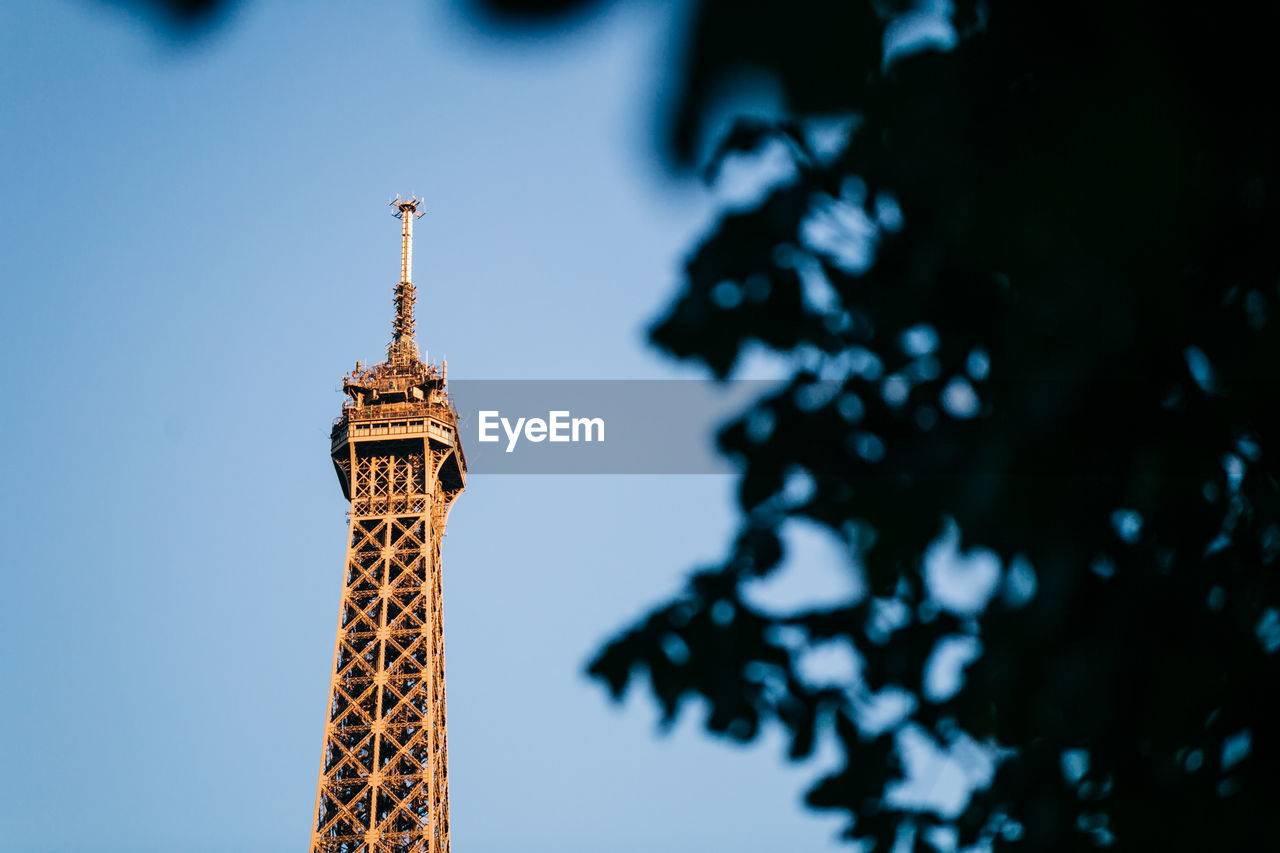 High section of eiffel tower against clear blue sky