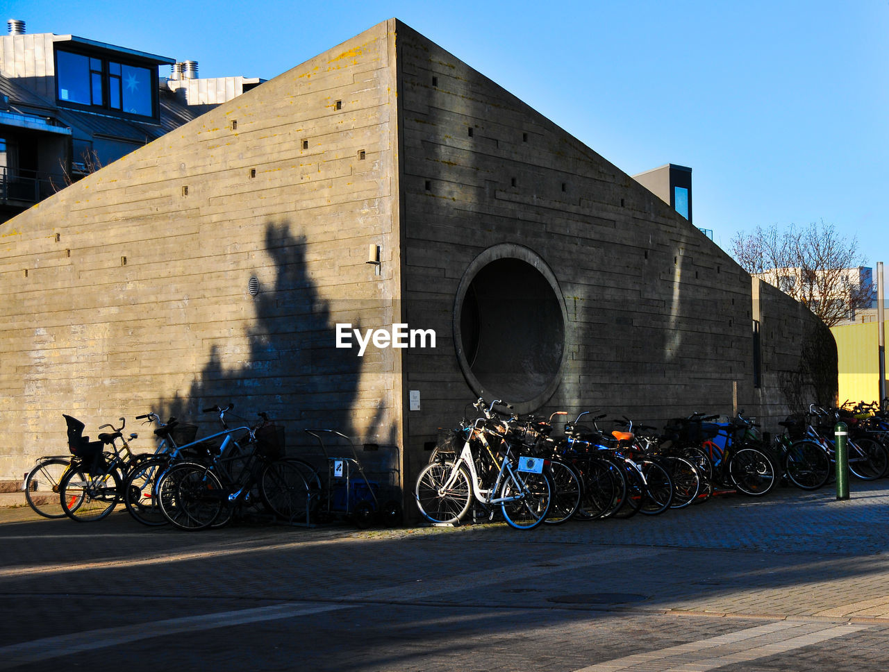 BICYCLES AGAINST SKY IN CITY