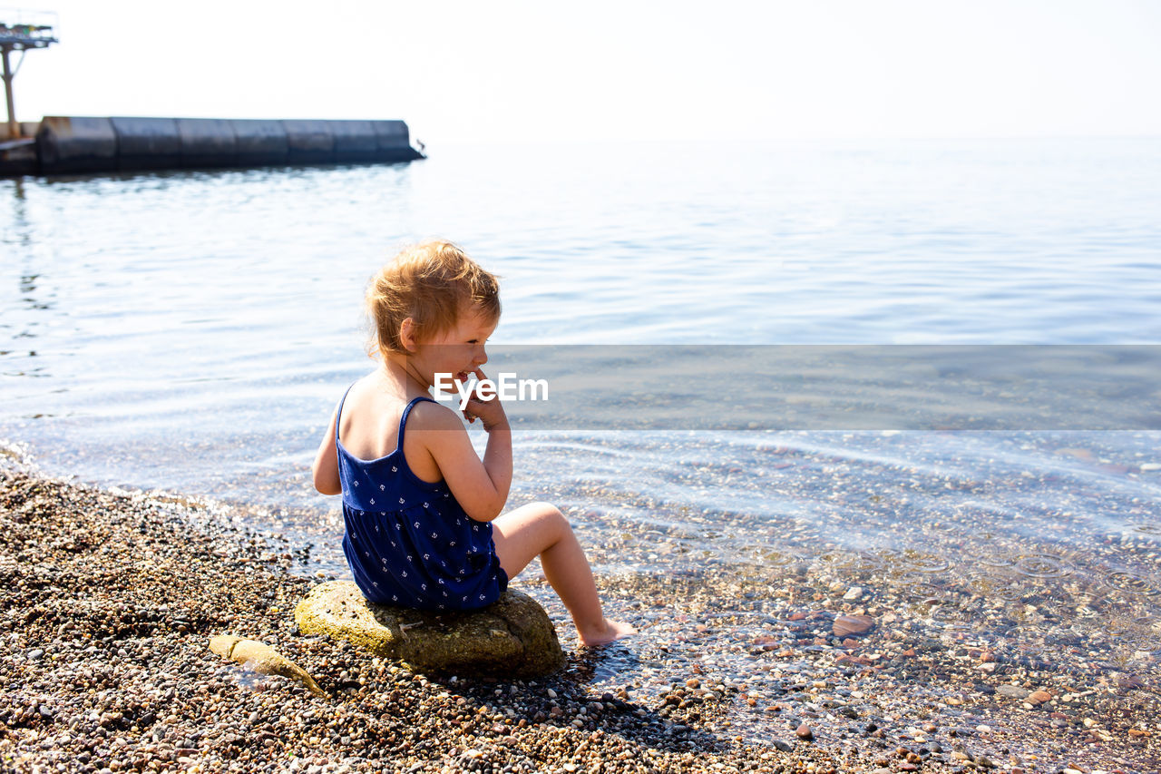 High angle view of woman sitting on beach