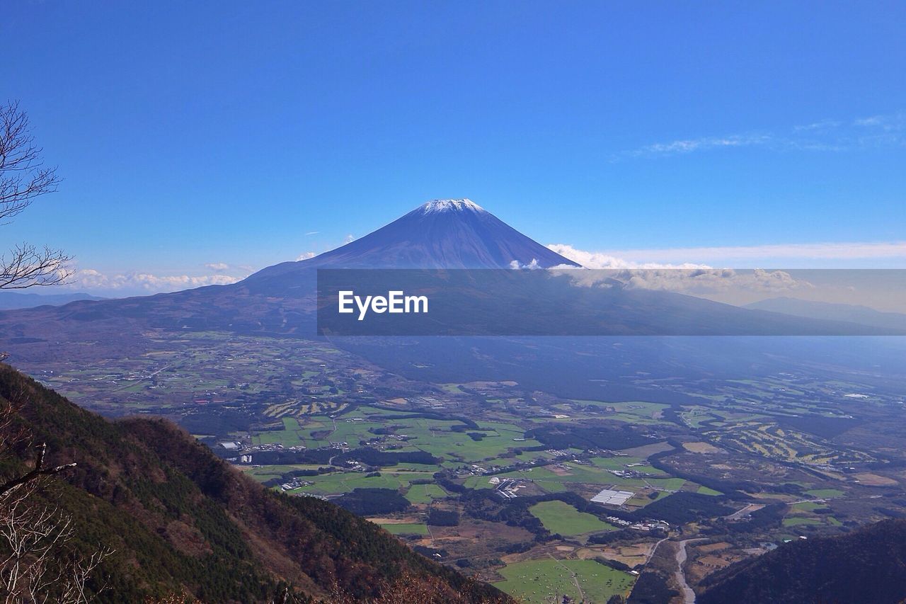 Aerial view of volcanic landscape against blue sky