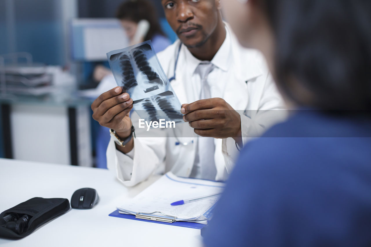 midsection of doctor examining patient in laboratory