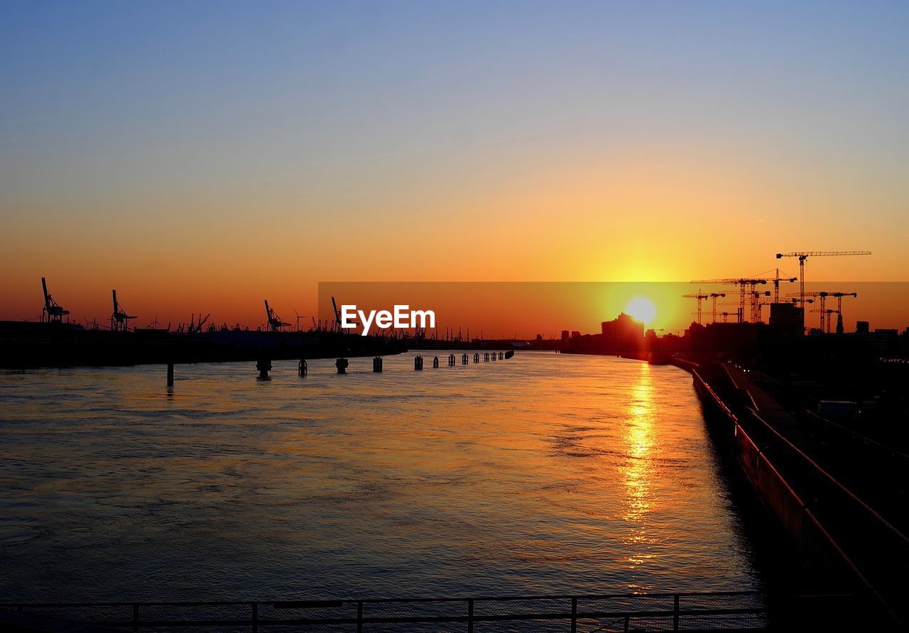 SILHOUETTE PIER OVER SEA AGAINST SKY DURING SUNSET