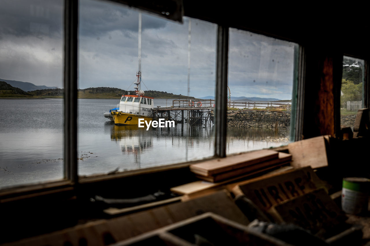 VIEW OF SEA SEEN THROUGH GLASS WINDOW