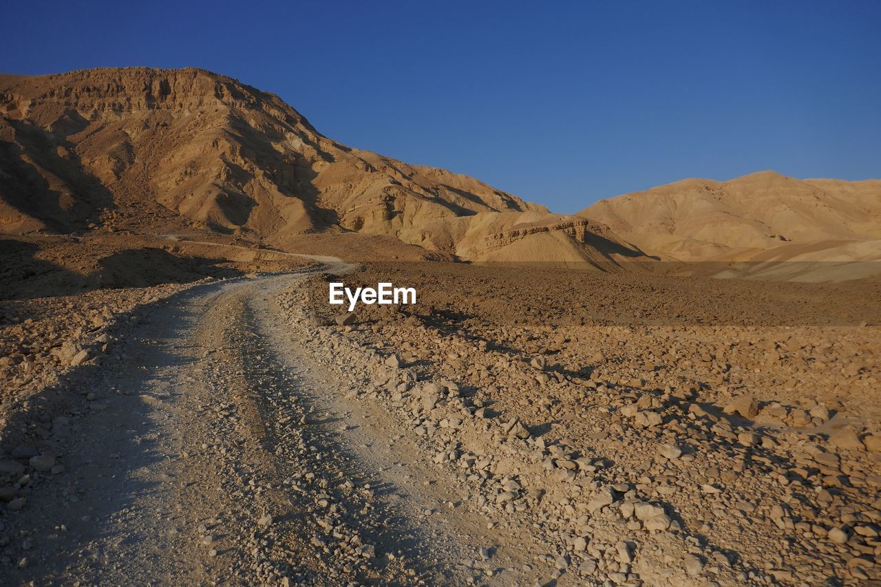 Scenic view of mountains against clear blue sky