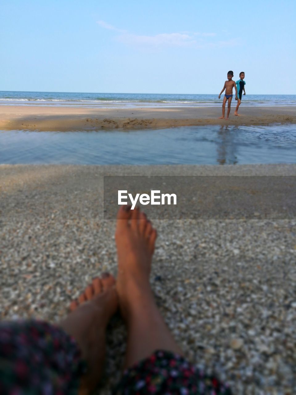 People at beach against sky