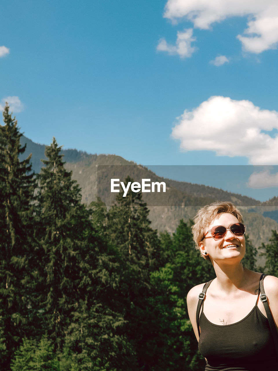 Portrait of woman in sunglasses against sky