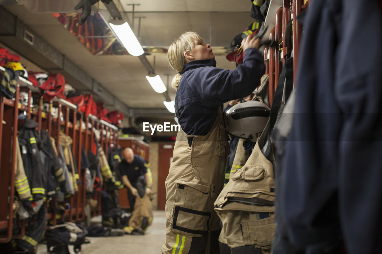 Female firefighter changing clothes in locker