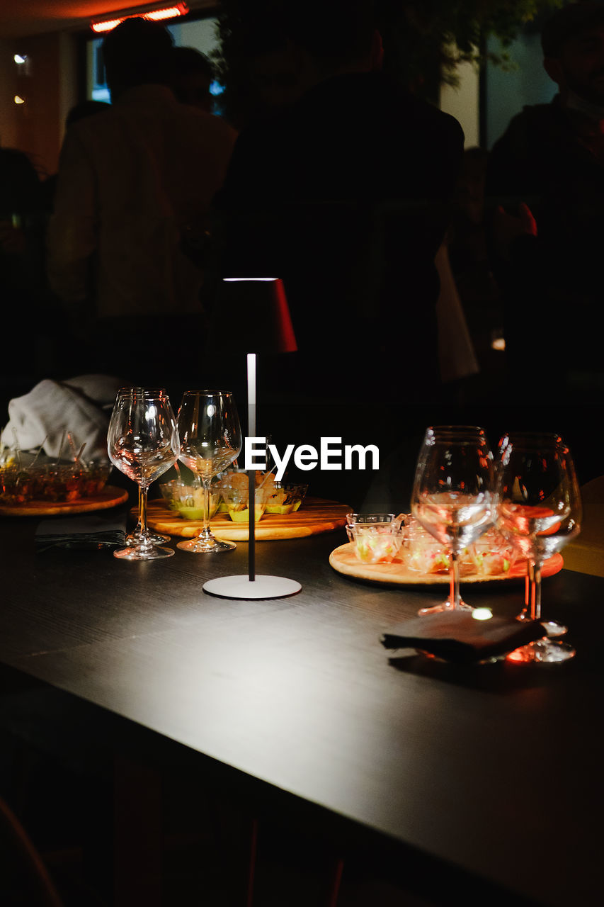 food and drink, food, table, glass, drink, refreshment, alcohol, wine, meal, wine glass, night, dinner, restaurant, indoors, tableware, household equipment, freshness, drinking glass, business, plate, dining table, lifestyles, adult, men, illuminated, bar