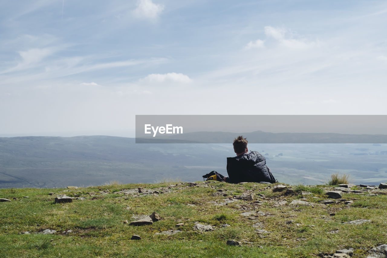 Rear view of man looking at mountain view