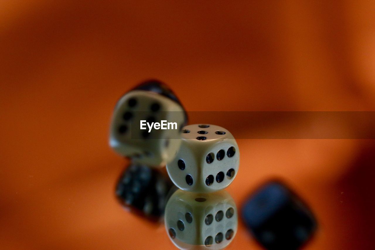 Close-up of dices on glass with reflections