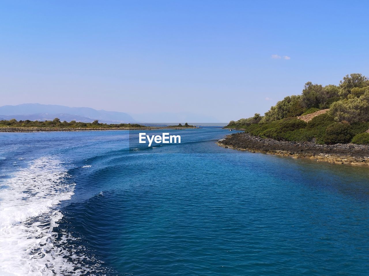 Scenic view of sea against clear blue sky