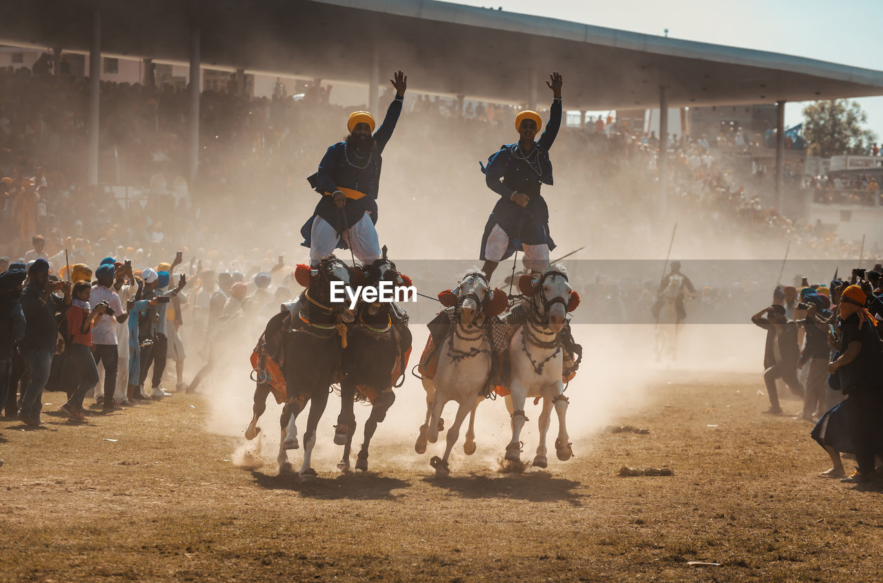 GROUP OF PEOPLE RIDING HORSE IN MARKET