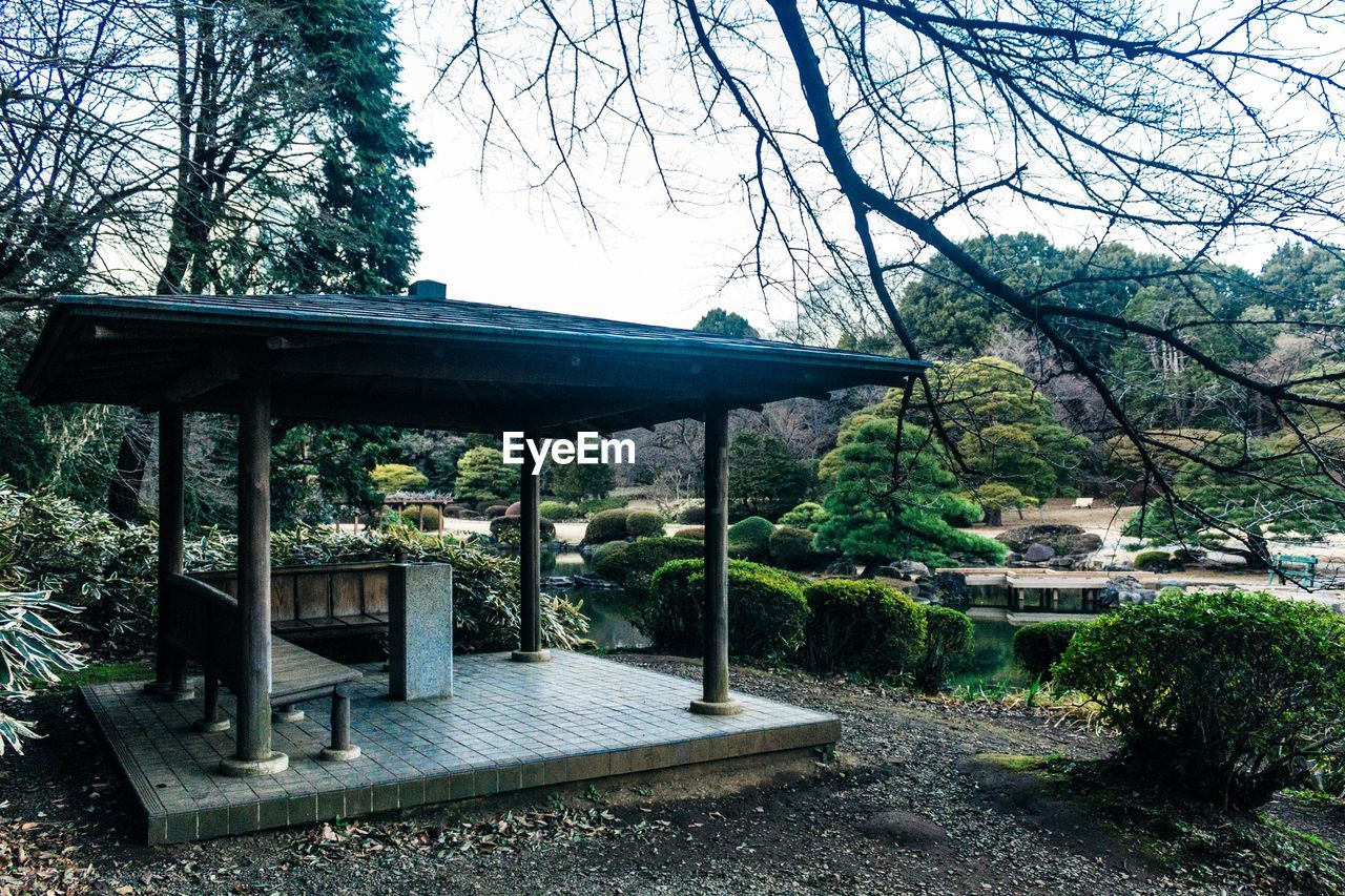 BUILT STRUCTURE BY TREES AGAINST SKY