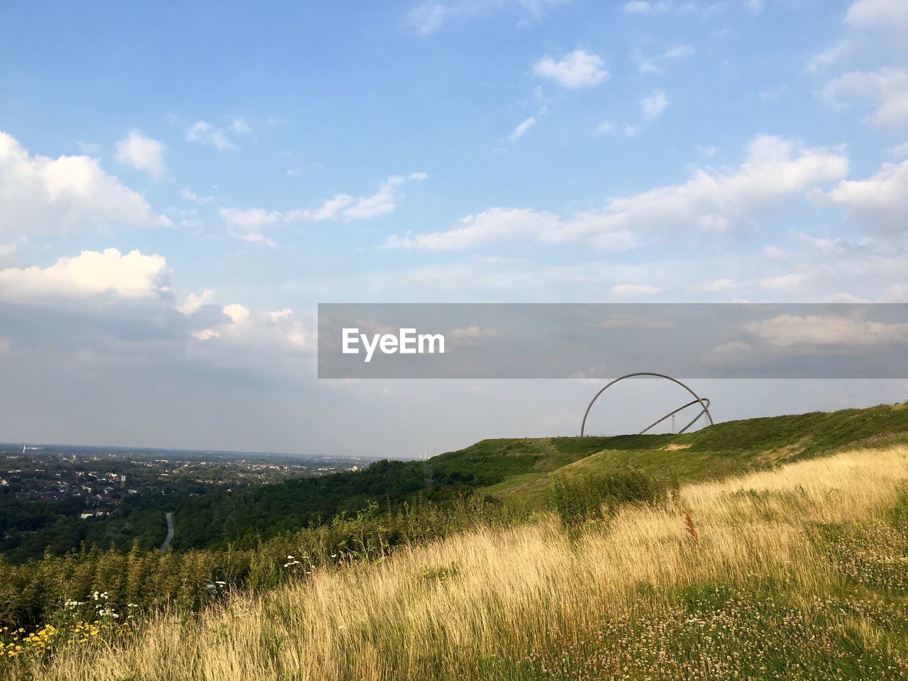 Scenic view of hill against sky