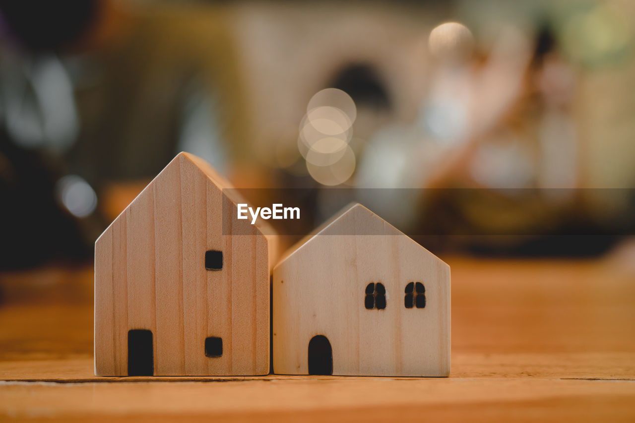 wood, toy, indoors, focus on foreground, childhood, creativity, toy block, table, architecture, selective focus