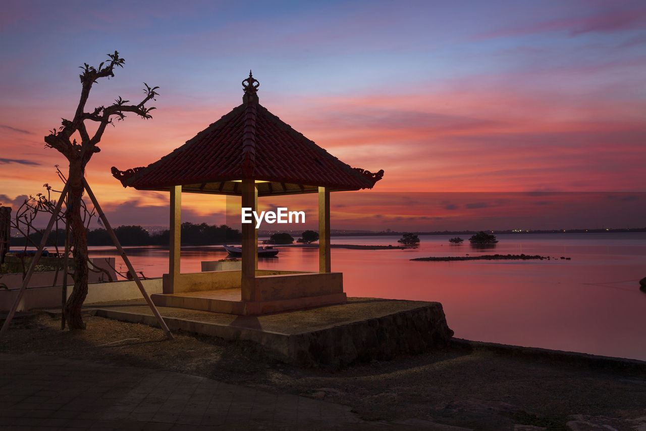 scenic view of beach against sky during sunset