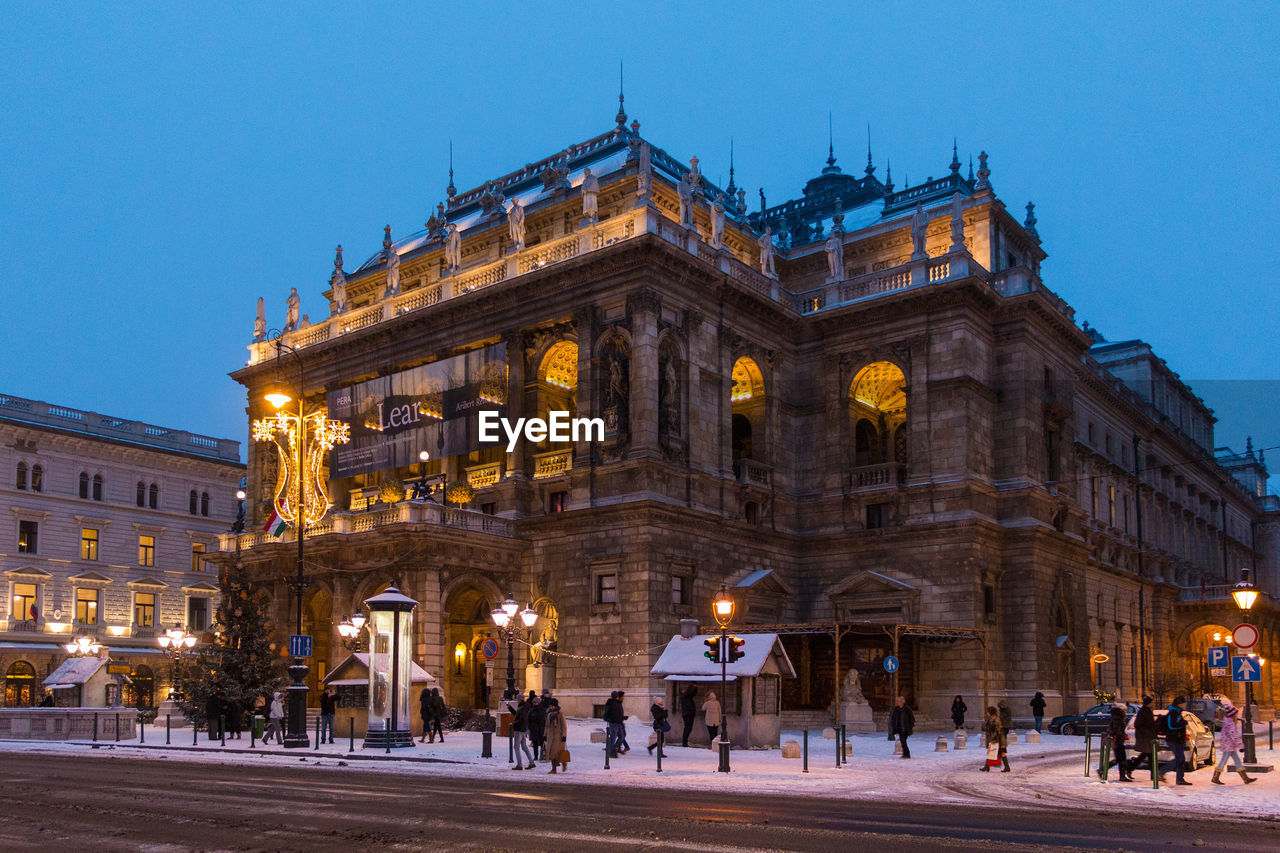 Illuminated hungarian state opera house during winter