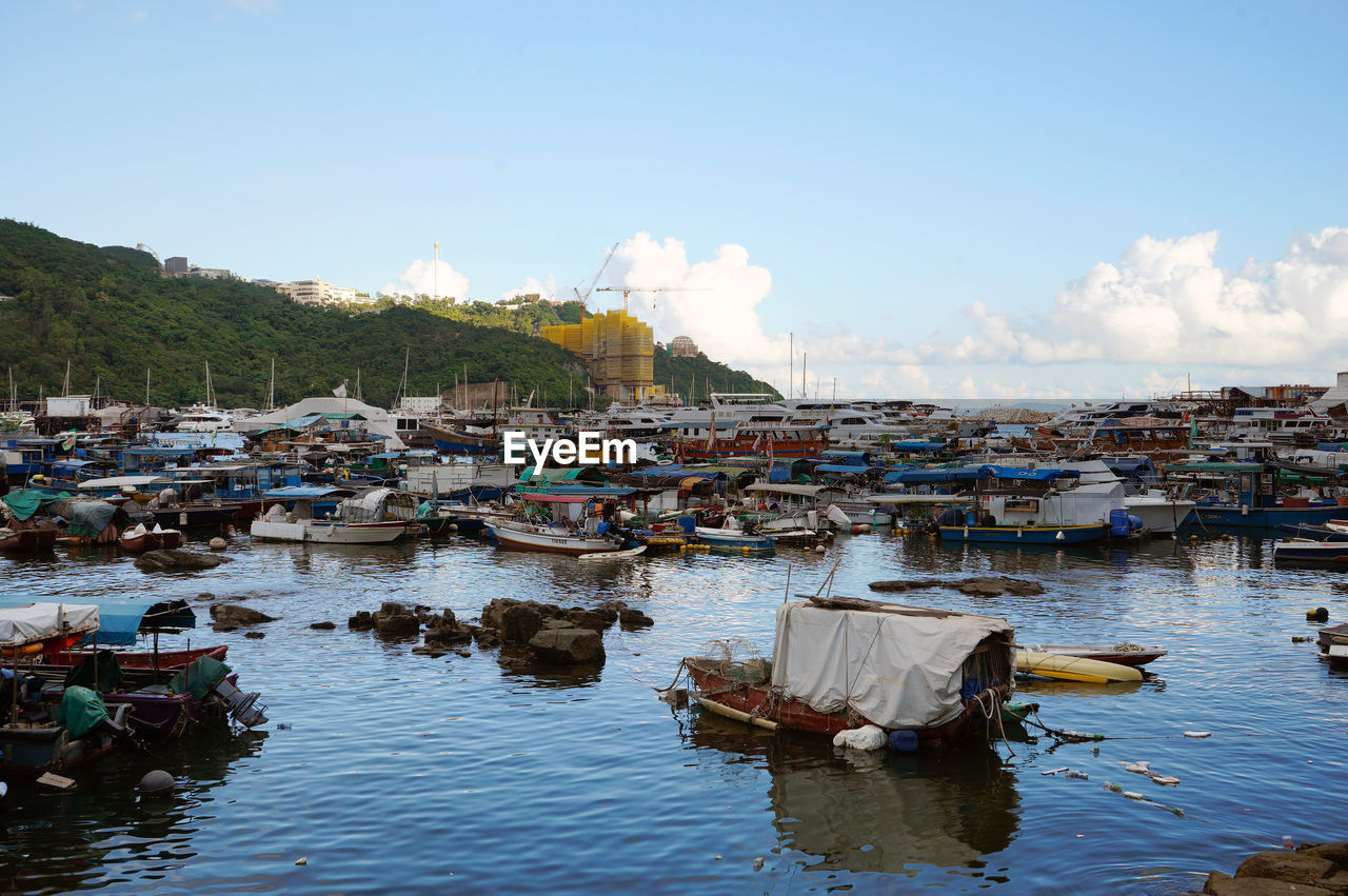 FISHING BOATS IN RIVER AGAINST BUILDINGS