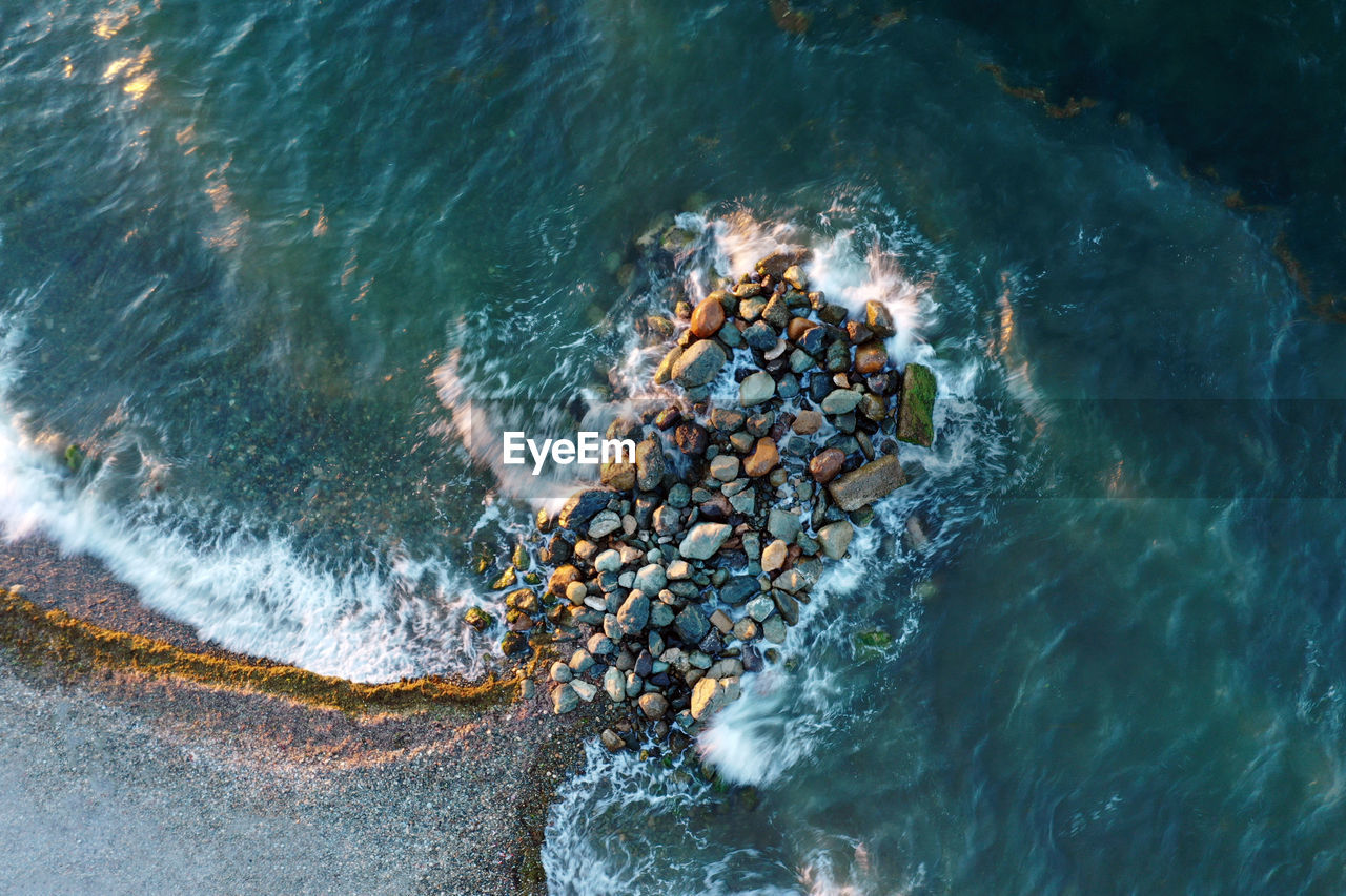 High angle view of rocks in sea