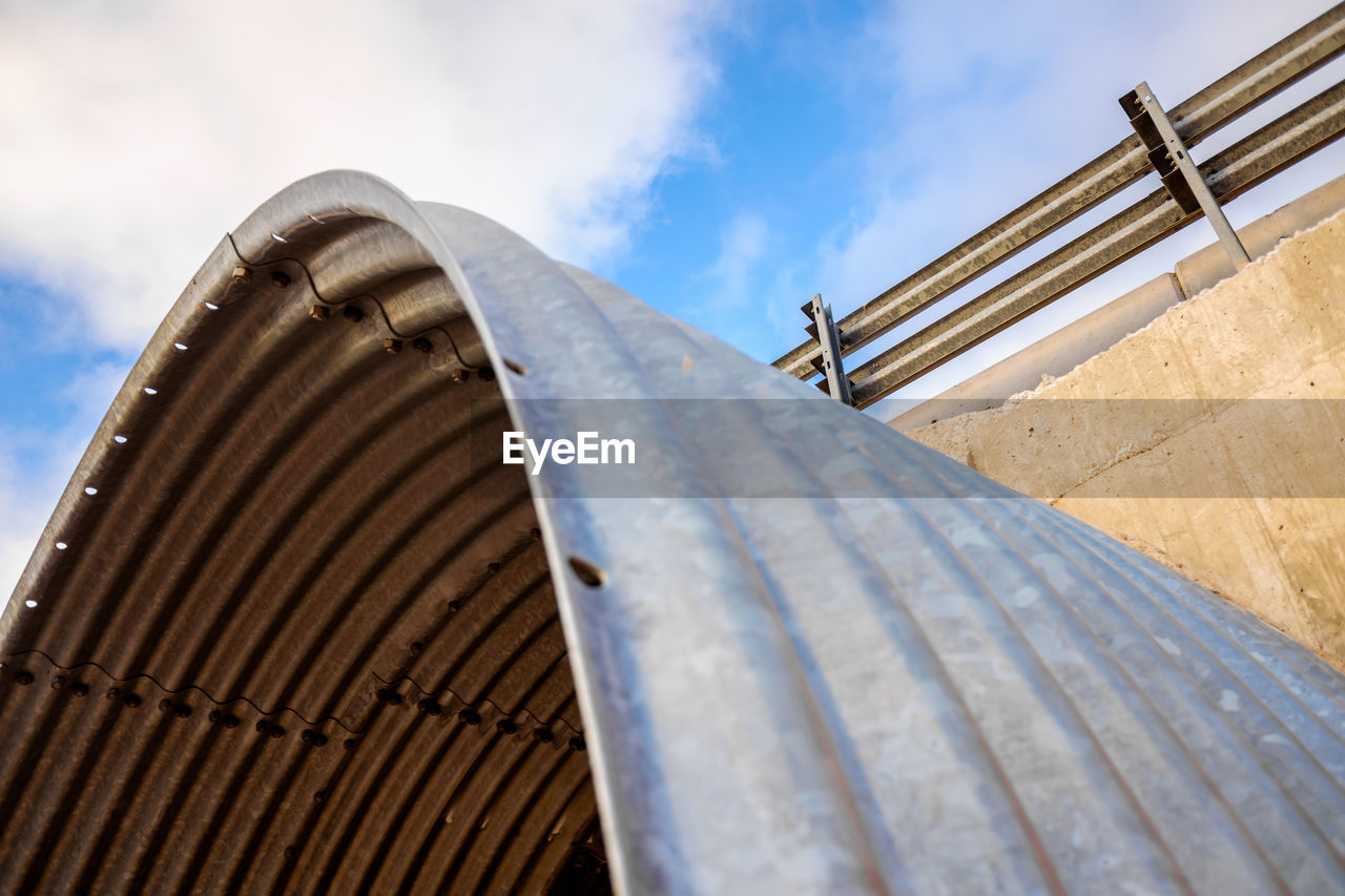 Low angle view of metallic structure against sky