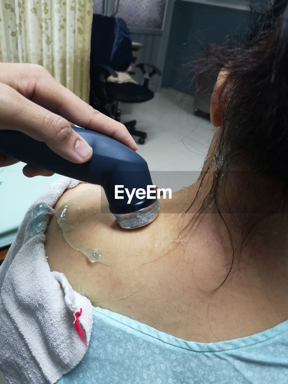 Cropped hand of woman giving shoulder massage to customer in spa