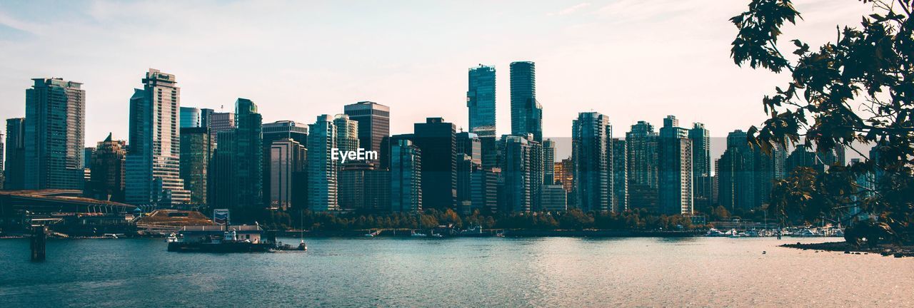 Panoramic view of modern buildings in city against sky