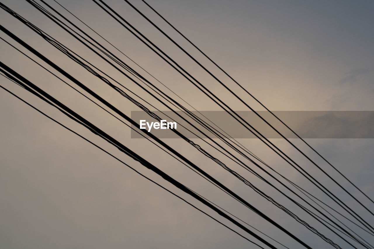 LOW ANGLE VIEW OF CABLES AGAINST THE SKY