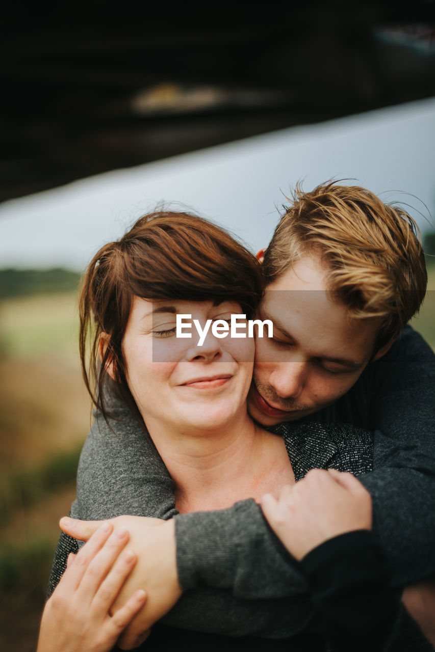 Smiling couple embracing in park