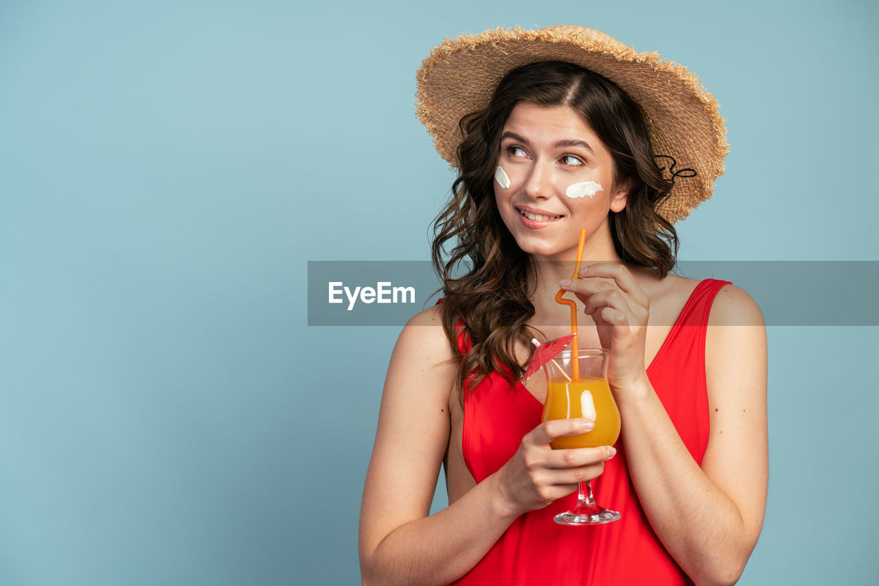 PORTRAIT OF A YOUNG WOMAN IN A DRINKING GLASS